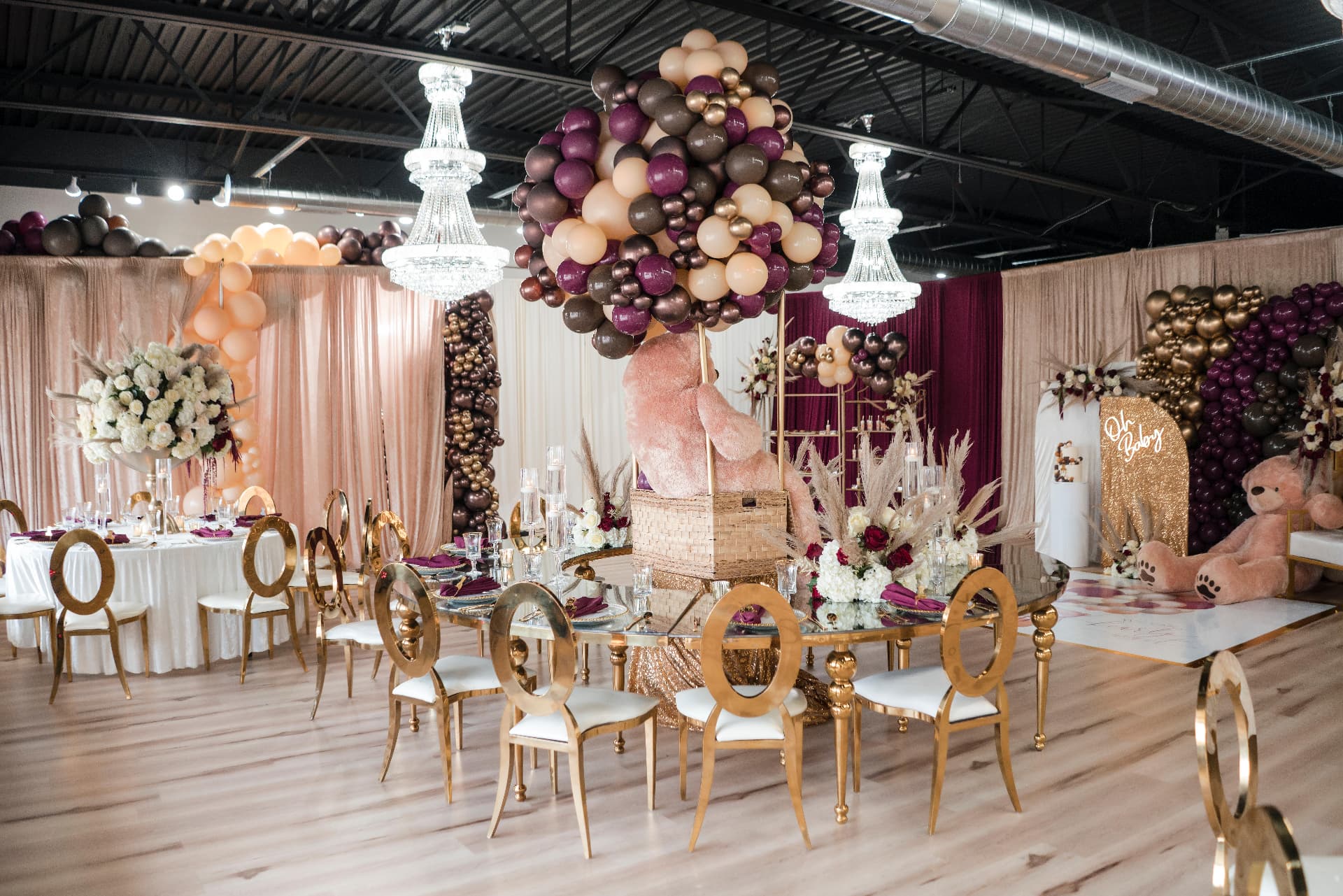 Baby shower ballroom with gold mirrored tablescape, balloon centerpiece and blush draping